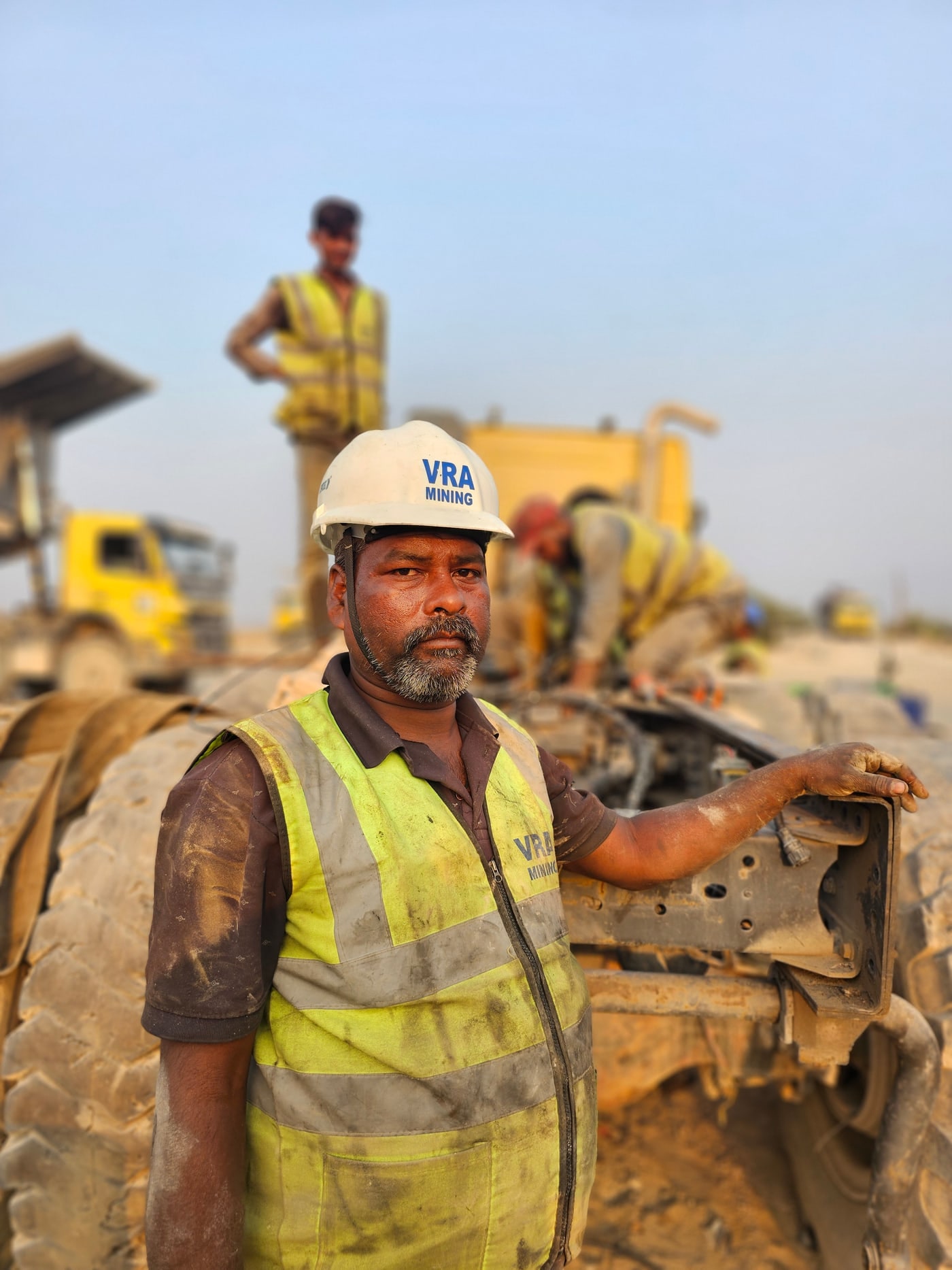 VRA technician in hard hat servicing the wheel end of a heavy mining hauler