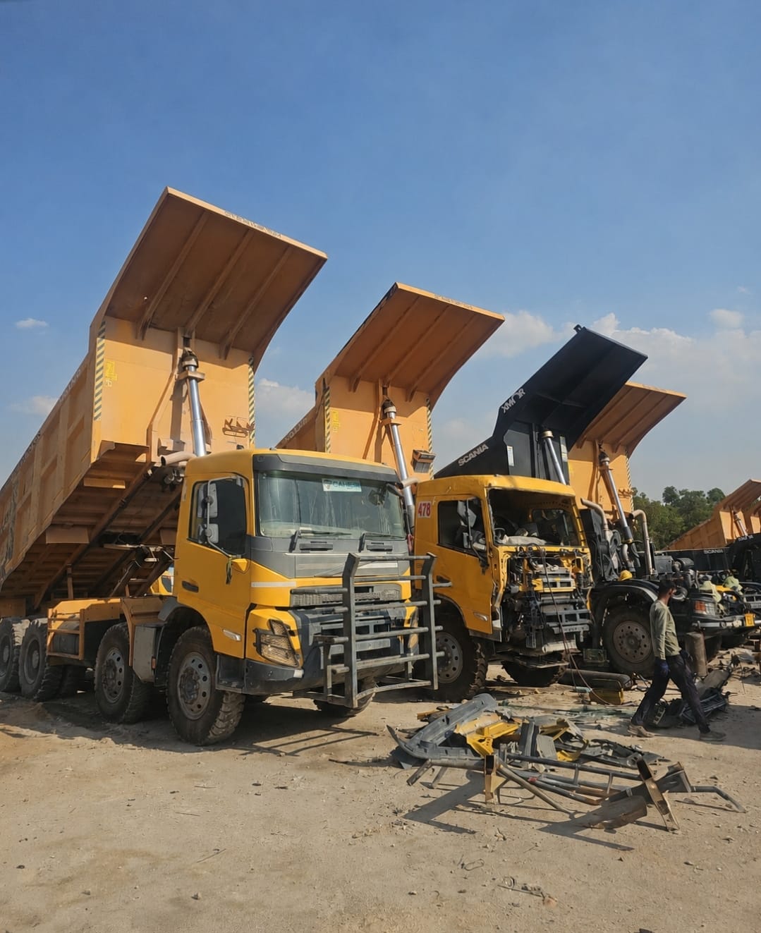 Line-up of Volvo and Scania mining tippers under accident repair at the VRA yard